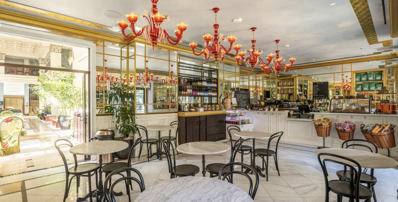 Elegant red chandeliers and marble tables create a chic atmosphere at Cafe Ora in downtown Los Angeles.