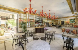 Elegant red chandeliers and marble tables create a chic atmosphere at Cafe Ora in downtown Los Angeles.