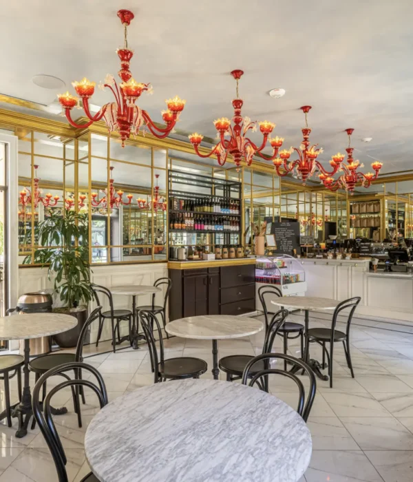 Elegant red chandeliers and marble tables create a chic atmosphere at Cafe Ora in downtown Los Angeles.