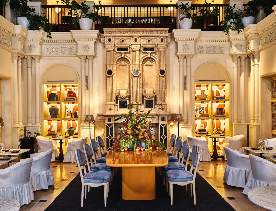 The ornate dining room at Ristorante Per L'Ora showcases grand architecture and elegant tables in downtown Los Angeles.