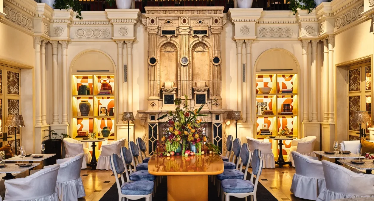 The ornate dining room at Ristorante Per L'Ora showcases grand architecture and elegant tables in downtown Los Angeles.