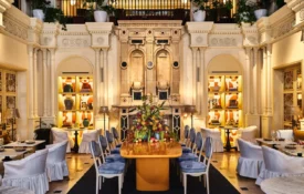 The ornate dining room at Ristorante Per L'Ora showcases grand architecture and elegant tables in downtown Los Angeles.