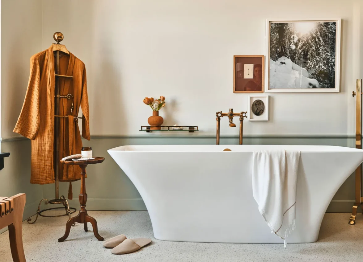 A white freestanding tub and waffle-knit robe in a bright suite at Hotel Per La in downtown Los Angeles.