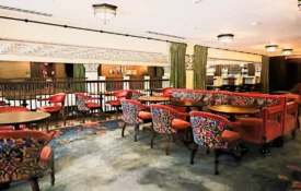 Ornate patterned chairs and red velvet sofas provide elegant seating at Ristorante Per L'Ora in Downtown LA.