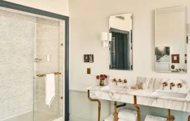 Double marble vanity and tiled walk-in shower in a luxury hotel suite in Los Angeles.