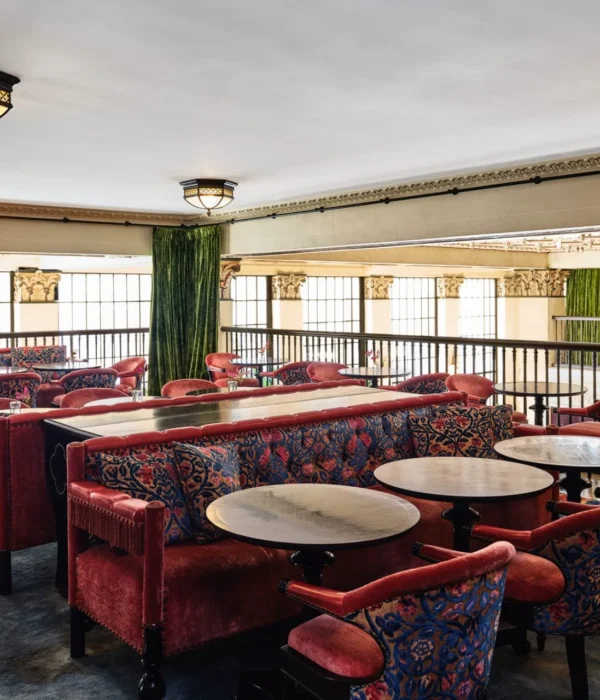 Plush red velvet booths and patterned chairs offer elegant seating at this boutique downtown LA restaurant.