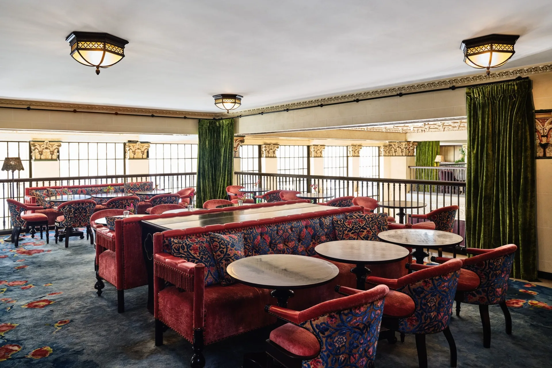 Plush red velvet booths and patterned chairs offer elegant seating at this boutique downtown LA restaurant.