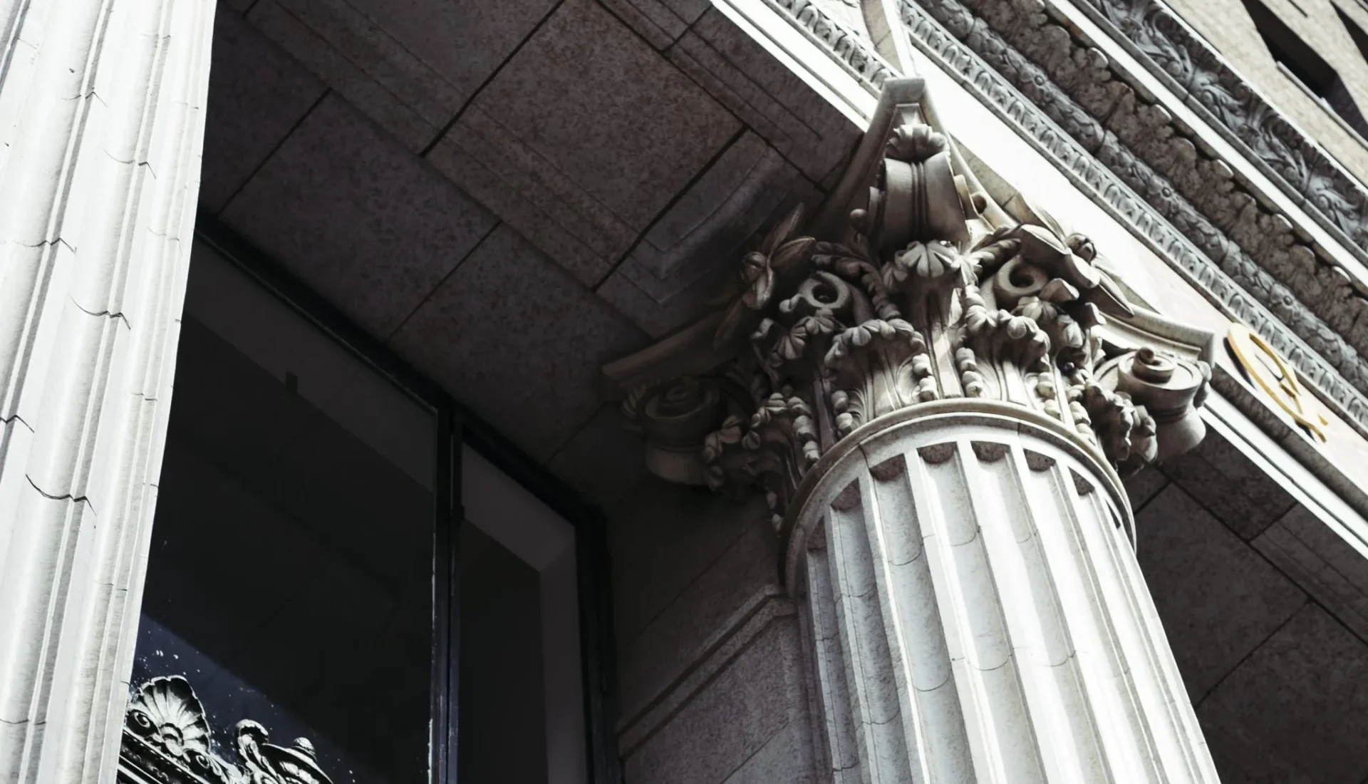 Intricate Corinthian columns and stone carvings decorate the exterior of this luxury boutique hotel in Los Angeles.