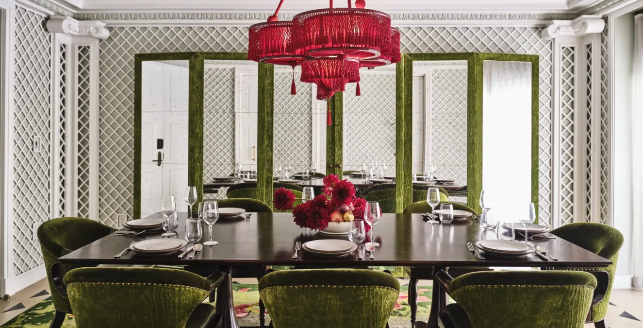 Green velvet chairs surround a long dining table at Ristorante Per L'Ora, an elegant event venue in Los Angeles.