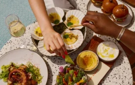 Diners enjoy fresh scallops and wine at Bar Clara, a premier rooftop bar and restaurant in downtown Los Angeles.