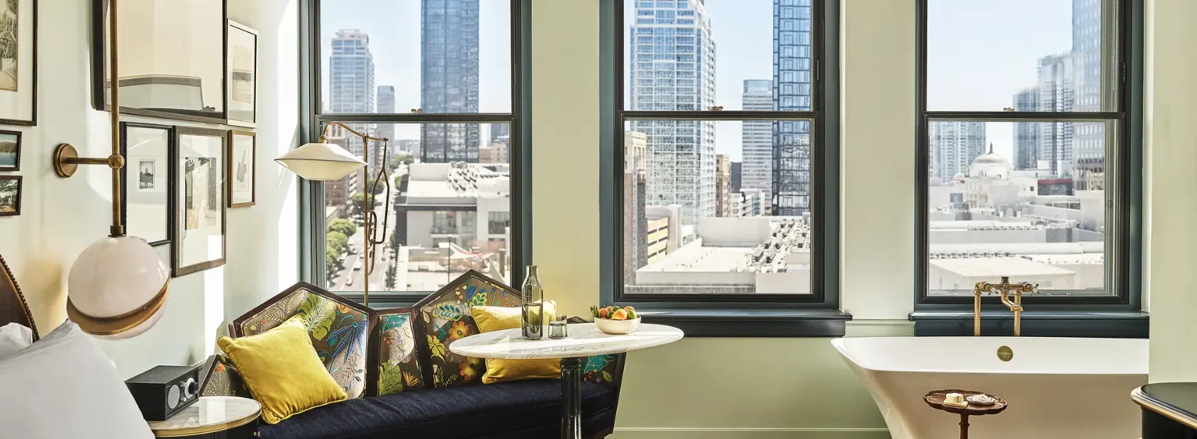 A hotel room with large bed and a soaking tub in the corner