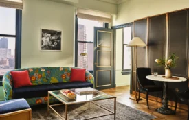 A glamorous living area in a hotel suite with views of LA