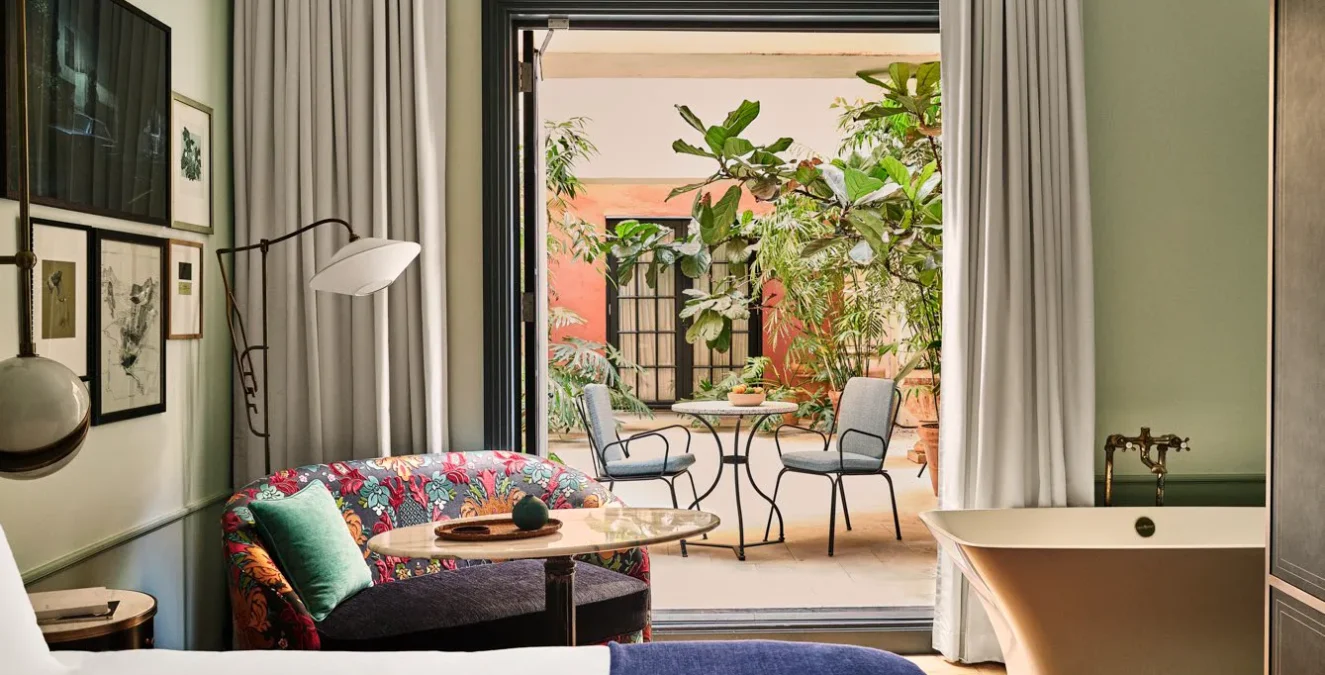 Patio Salon. Bedroom with doors oped to the patio area.