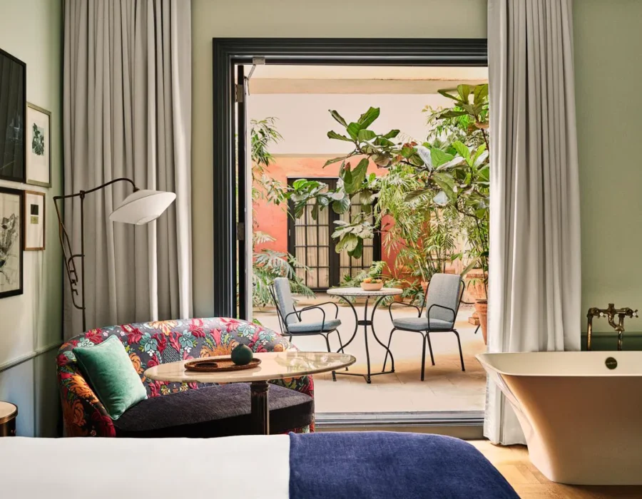 Patio Salon. Bedroom with doors oped to the patio area.