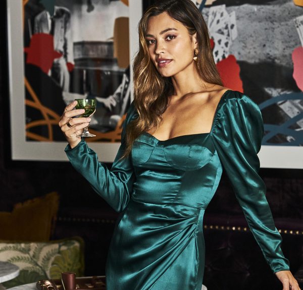 Woman in elegant gown holding a beverage