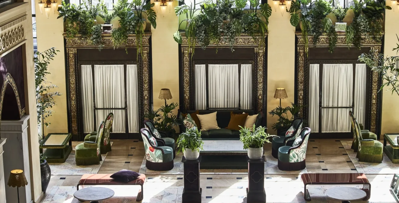 Ornate architectural details and lush greenery frame an elegant seating area in this boutique hotel in Los Angeles.