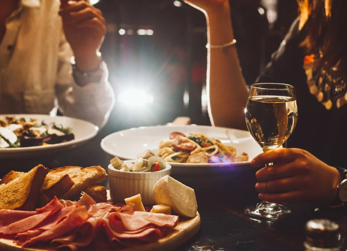 Diners enjoy fresh pasta and wine at Ristorante Per L'Ora, one of the top Italian restaurants in Los Angeles.