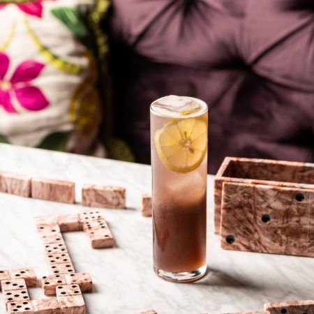 A chilled lemon cocktail and marble dominoes set the scene at our rooftop bar in Los Angeles.