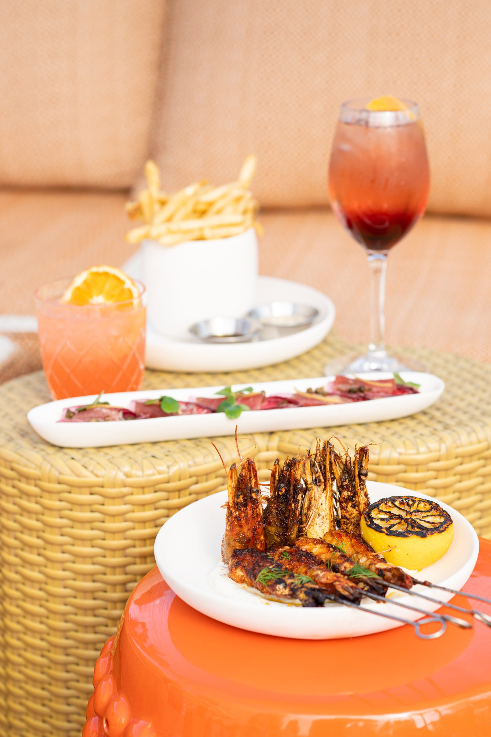 Grilled shrimp skewers and refreshing cocktails served at Bar Clara, a premier rooftop bar in Los Angeles, CA.