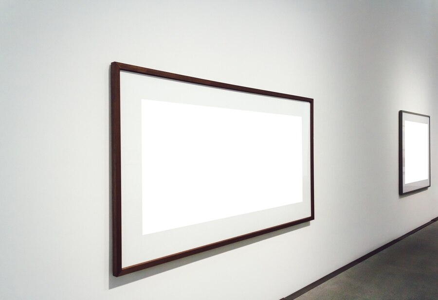 Two minimalist wooden frames hang on a white wall in a modern event space at our luxury boutique hotel in Los Angeles.