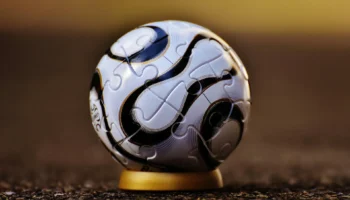 a soccer ball sitting on top of a wooden floor