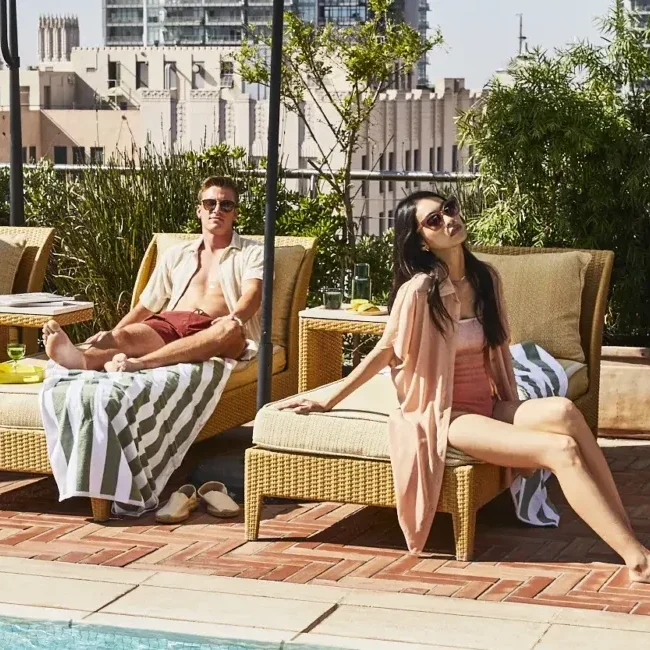 Couple hanging out at rooftop pool