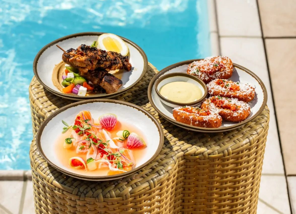 Gourmet appetizers served poolside at Bar Clara, a premier rooftop pool hotel in Los Angeles.