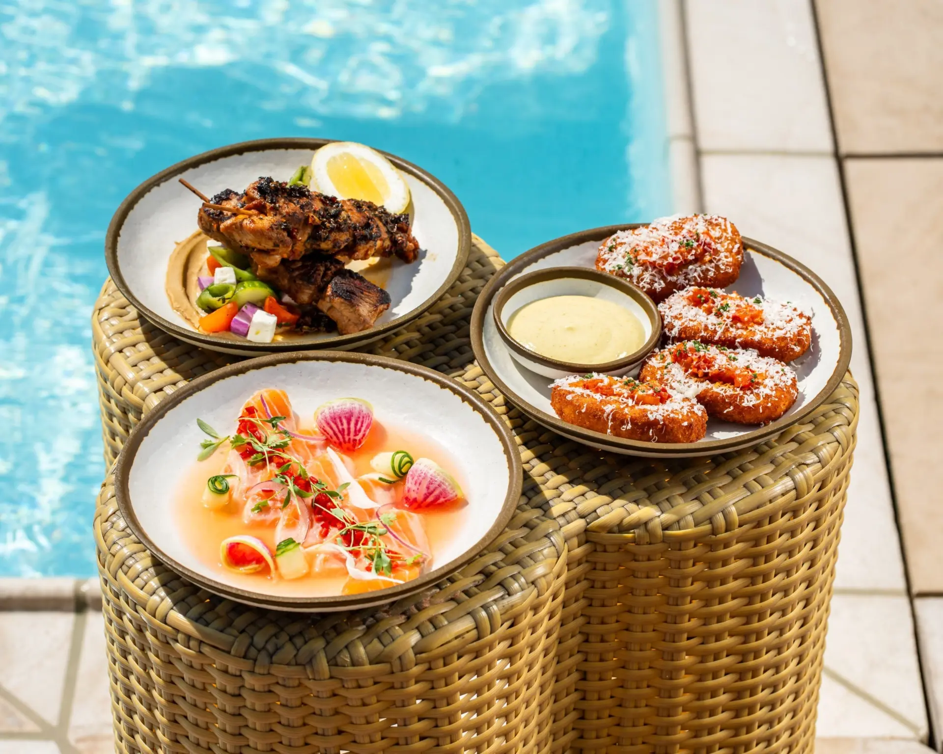 Gourmet appetizers served poolside at Bar Clara, a premier rooftop pool hotel in Los Angeles.