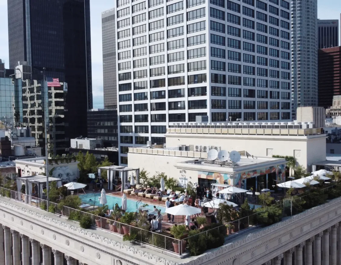 Sunbathers enjoy the rooftop pool and Bar Clara with panoramic views of downtown Los Angeles skyscrapers.