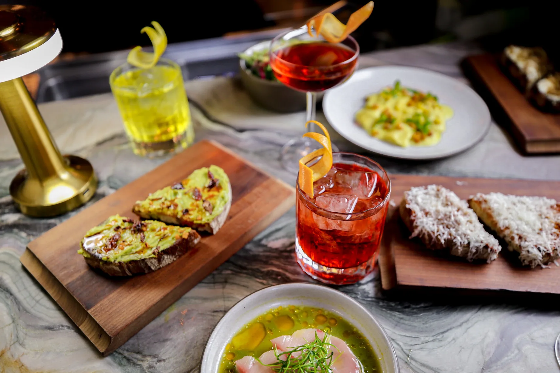 Vibrant cocktails and authentic Italian dishes create an inviting spread at Ristorante Per L'Ora in downtown LA.