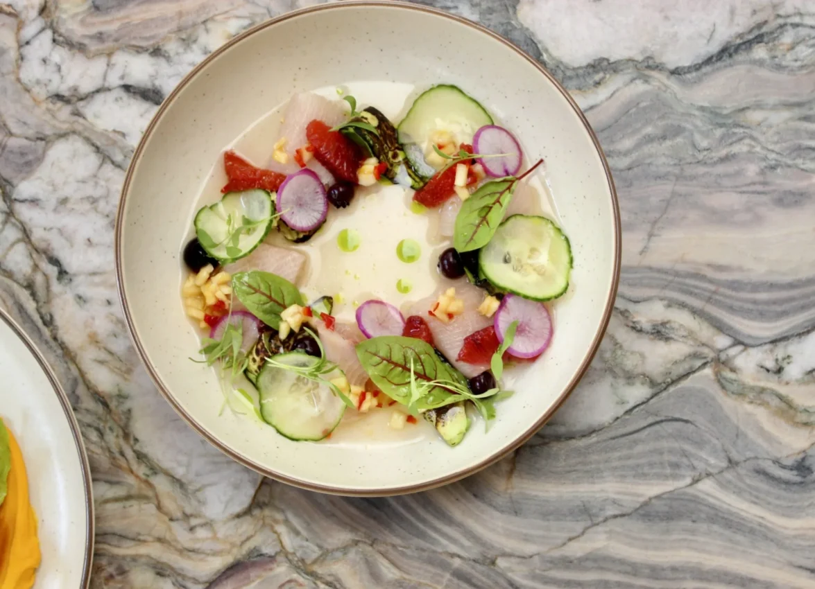 A vibrant seafood crudo dish with cucumber and radish served at Ristorante Per L'Ora in downtown Los Angeles.