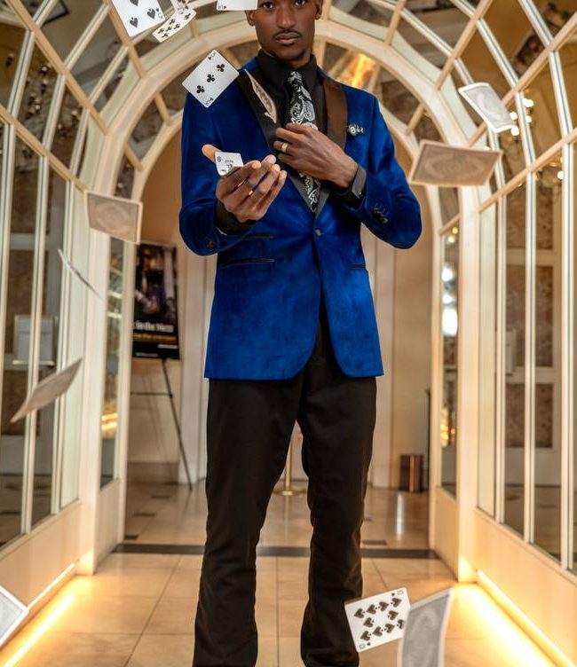 The Visionary Noir throwing playing cards in the air at Hotel Per La
