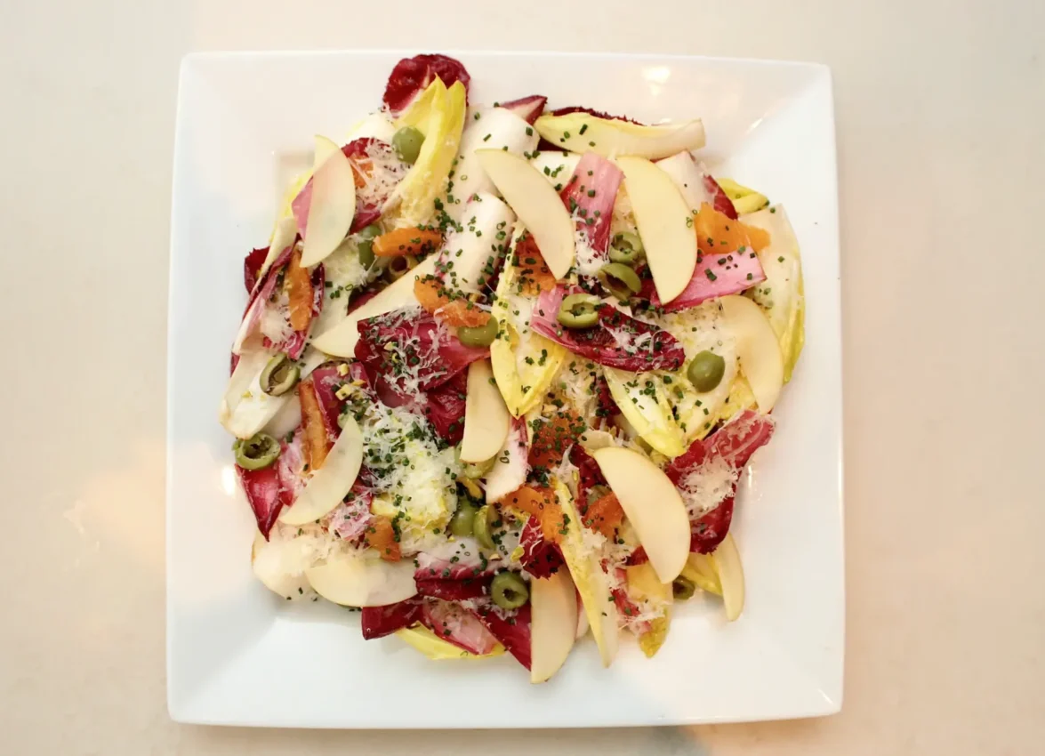 A vibrant radicchio and endive salad with apple slices served at one of the finest downtown LA restaurants.
