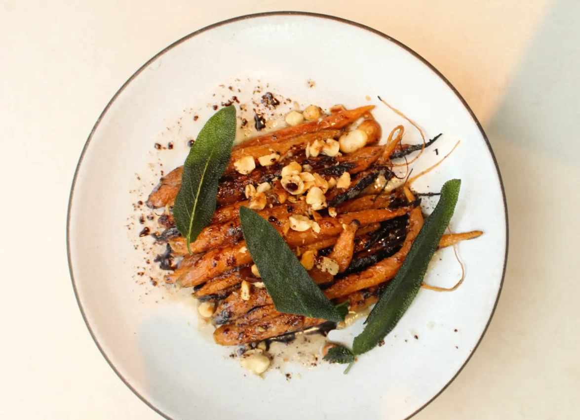 Gourmet roasted carrots with sage and nuts served at Ristorante Per L'Ora, a top Italian restaurant in Los Angeles.