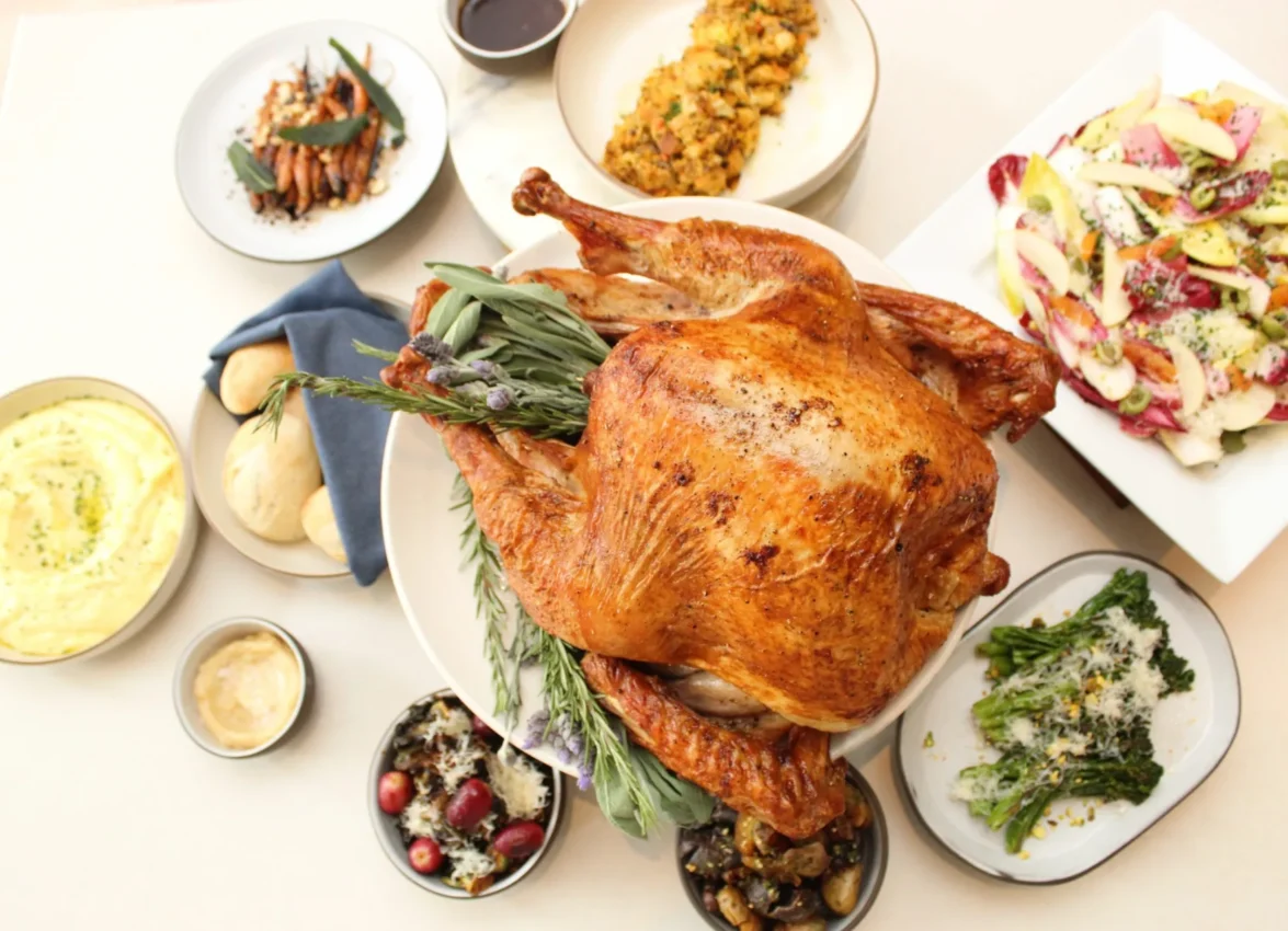 A perfectly roasted turkey centerpiece surrounded by gourmet sides at Ristorante Per L'Ora.
