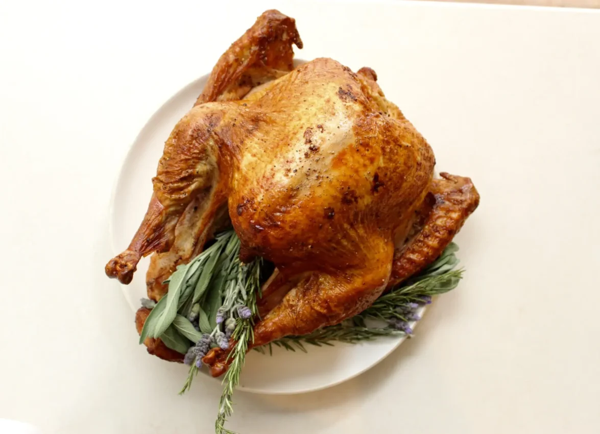 A perfectly golden roasted turkey garnished with fresh herbs at one of the top downtown LA restaurants.