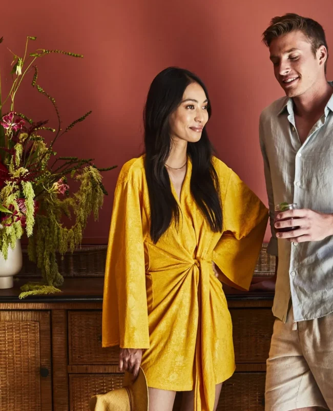 A stylish couple enjoys drinks near a vibrant floral arrangement at our luxury boutique hotel in Los Angeles.