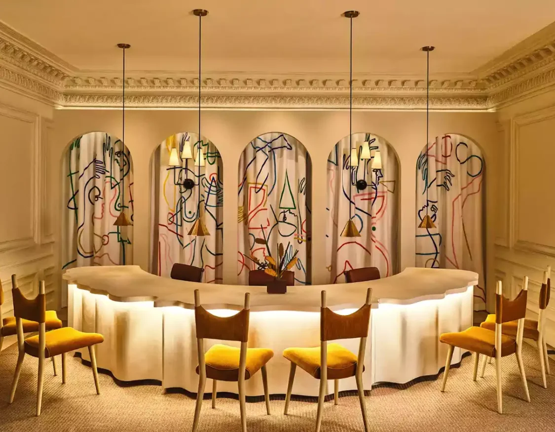 a room with a circular table and chairs